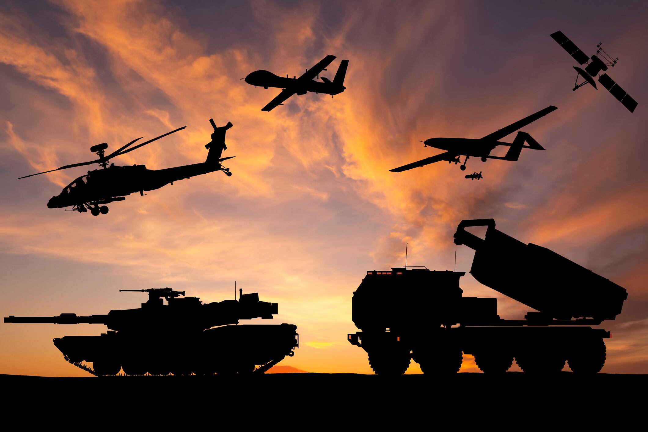 Armored tanks, combat drone and missile launcher at sunset. Modern US military equipment