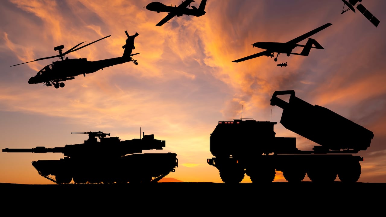 Armored tanks, combat drone and missile launcher at sunset. Modern US military equipment