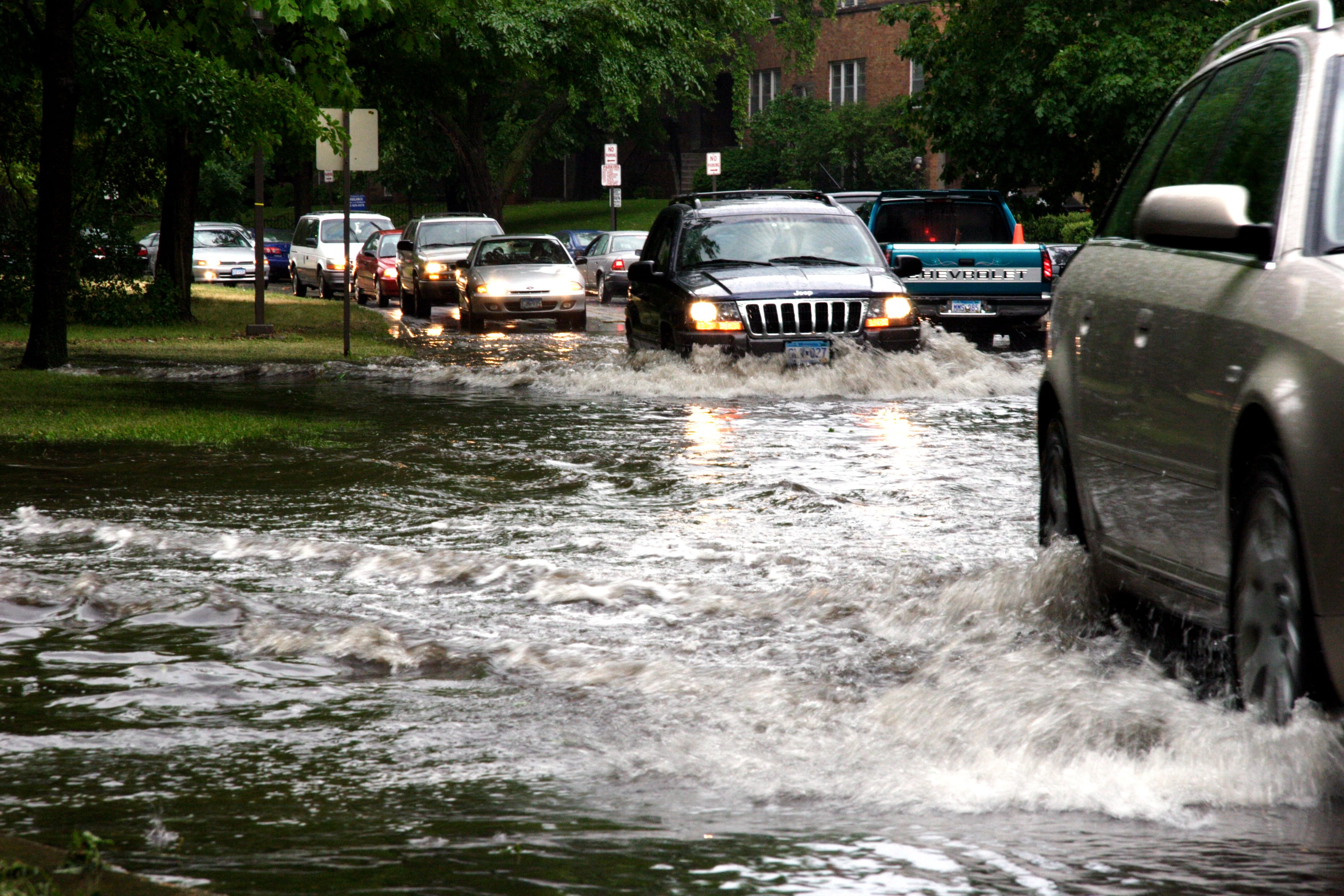 Cars took turns navigating through the flood waters on dean pkwy. Some cars did not make it and were pushed out of the collecting water. Many trees fell during the storm.
