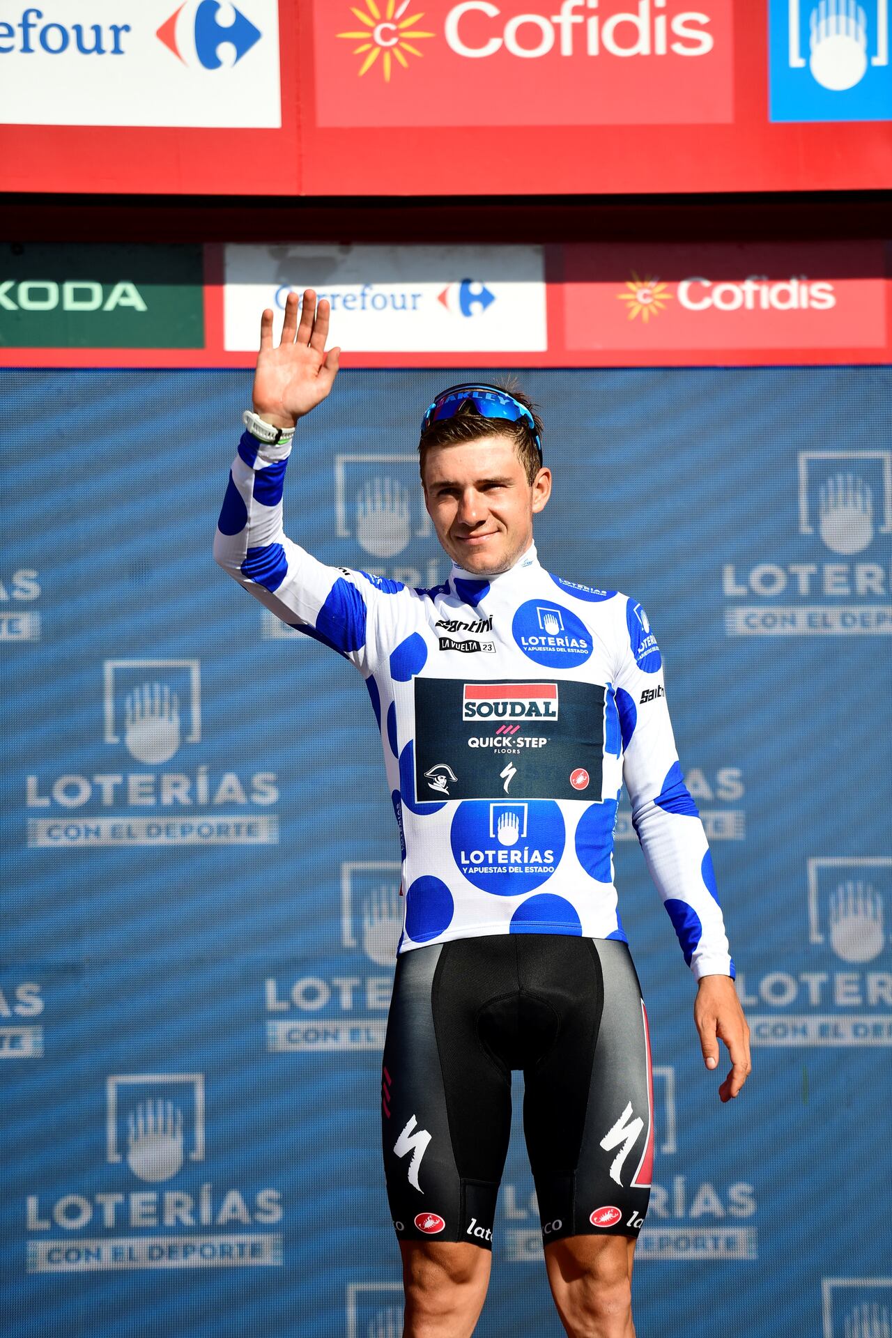 Team Quick Step's Belgian rider Remco Evenepoel celebrates on the podium wearing the best climber's dotted jersey after the stage 15 of the 2023 La Vuelta cycling tour of Spain, a 158,3 km race between Pamplona and Lekunberri on September 10, 2023. (Photo by ANDER GILLENEA / AFP)