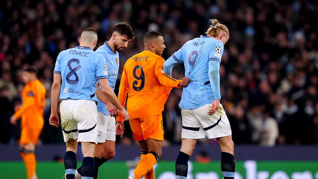 Real Madrid's Kylian Mbappe and Manchester City's Erling Haaland grapple with each other during the UEFA Champions League Knockout Phase Play Offs, first leg match at the Etihad Stadium, Manchester. Picture date: Tuesday February 11, 2025. (Photo by Mike Egerton/PA Images via Getty Images)