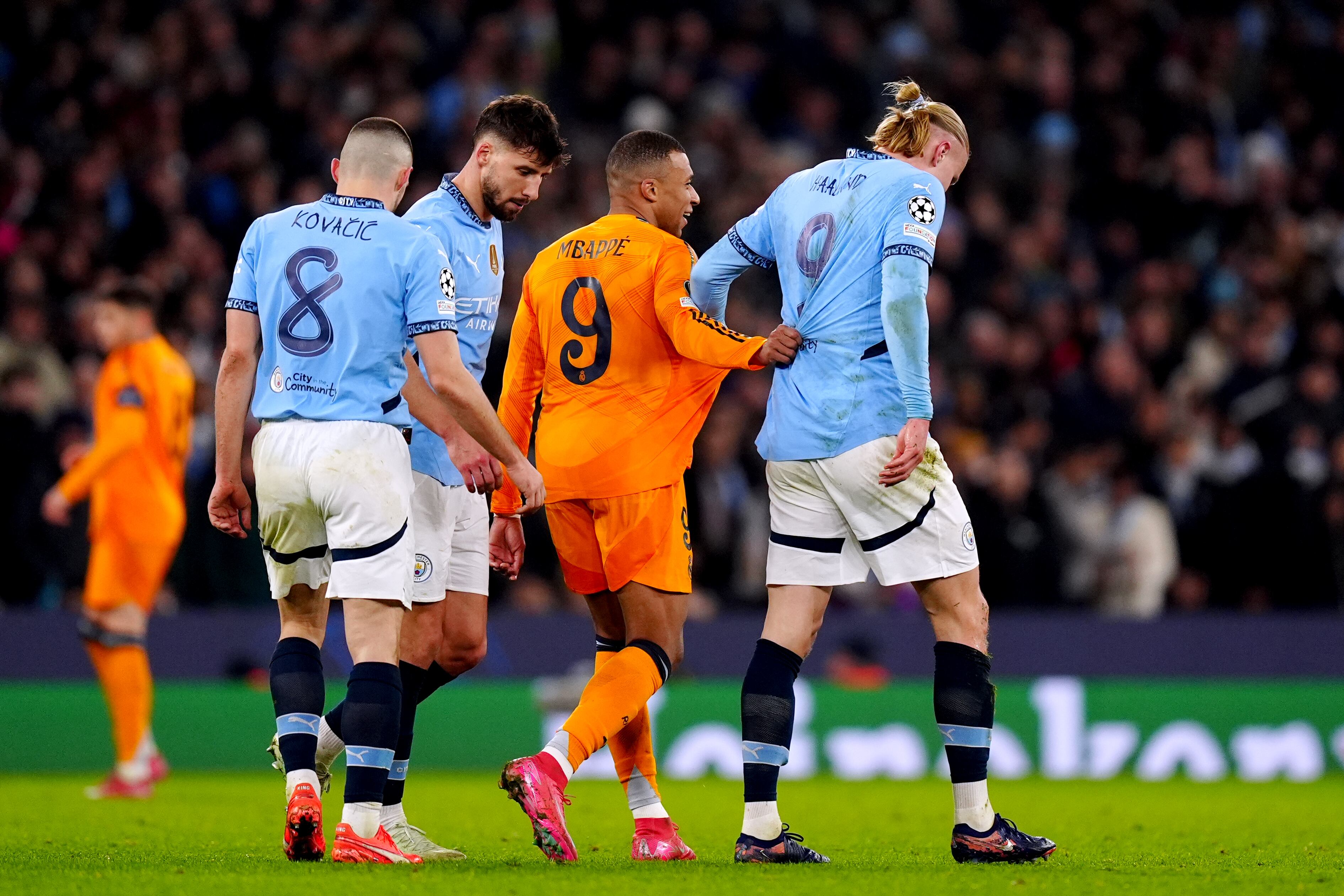 Real Madrid's Kylian Mbappe and Manchester City's Erling Haaland grapple with each other during the UEFA Champions League Knockout Phase Play Offs, first leg match at the Etihad Stadium, Manchester. Picture date: Tuesday February 11, 2025. (Photo by Mike Egerton/PA Images via Getty Images)