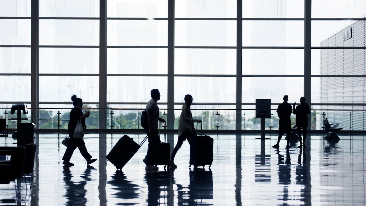 View of airport departures area travellers rushing.