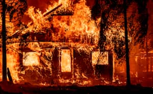 (FILES) In this file photo taken on July 25, 2021 a home burns as flames from the Dixie fire tear through the Indian Falls neighborhood of unincorporated Plumas County, California. - Britain on Monday, August 9, called for urgent global action to tackle climate change, after a UN report warned the planet has warmed more than previously estimated. (Photo by JOSH EDELSON / AFP)