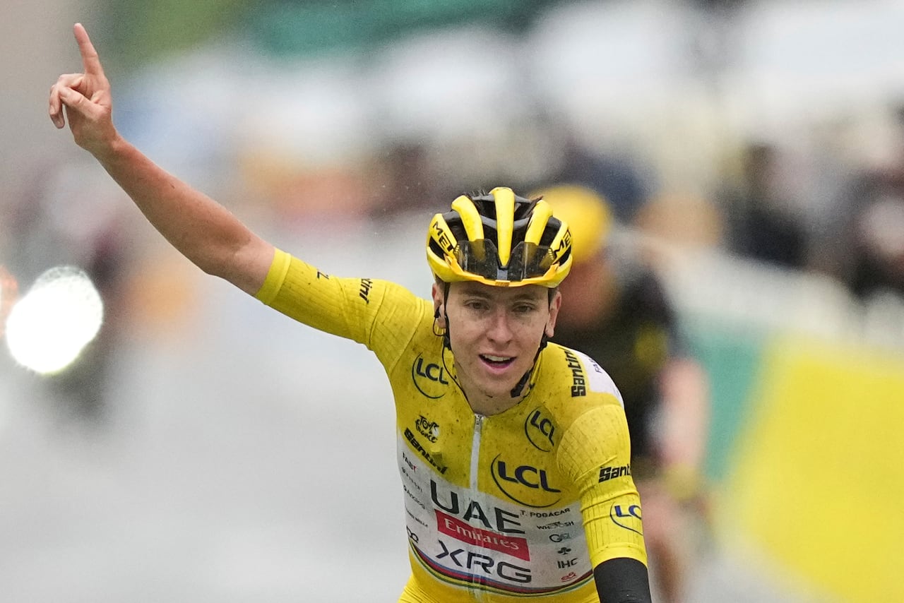 Tour de France winner Tadej Pogacar of Slovenia crosses the finish line of the twenty-first stage of the Tour de France cycling race over 132.3 kilometers (82.1 miles) with start in Mantes-la-Ville and finish on the Champs-Elysees in Paris, France, Sunday, July 27, 2025. (AP Photo/Thibault Camus)