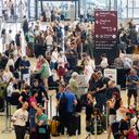 Passengers wait in front of check-in counters at the capital's Berlin Brandenburg Airport, in Schönefeld, Germany, Friday July 19, 2024, after a widespread technology outage disrupted flights, banks, media outlets and companies around the world. (Christoph Soeder/dpa via AP)