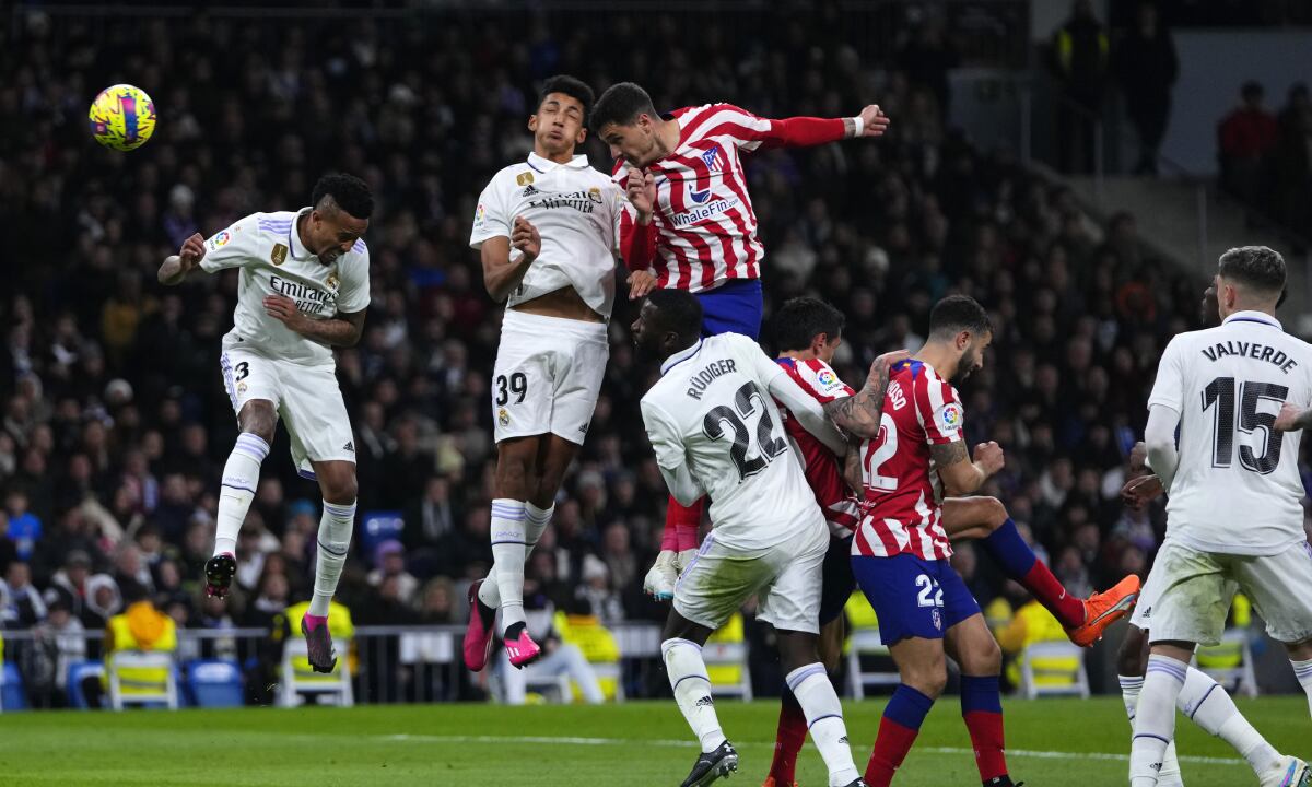Atletico Madrid's Jose Gimenez, top right, heads the ball to scores his side's opening goal during a Spanish La Liga soccer match between Real Madrid and Atletico Madrid at the Santiago Bernabeu stadium in Madrid, Spain, Saturday, Feb. 25, 2023. (AP/Manu Fernandez)