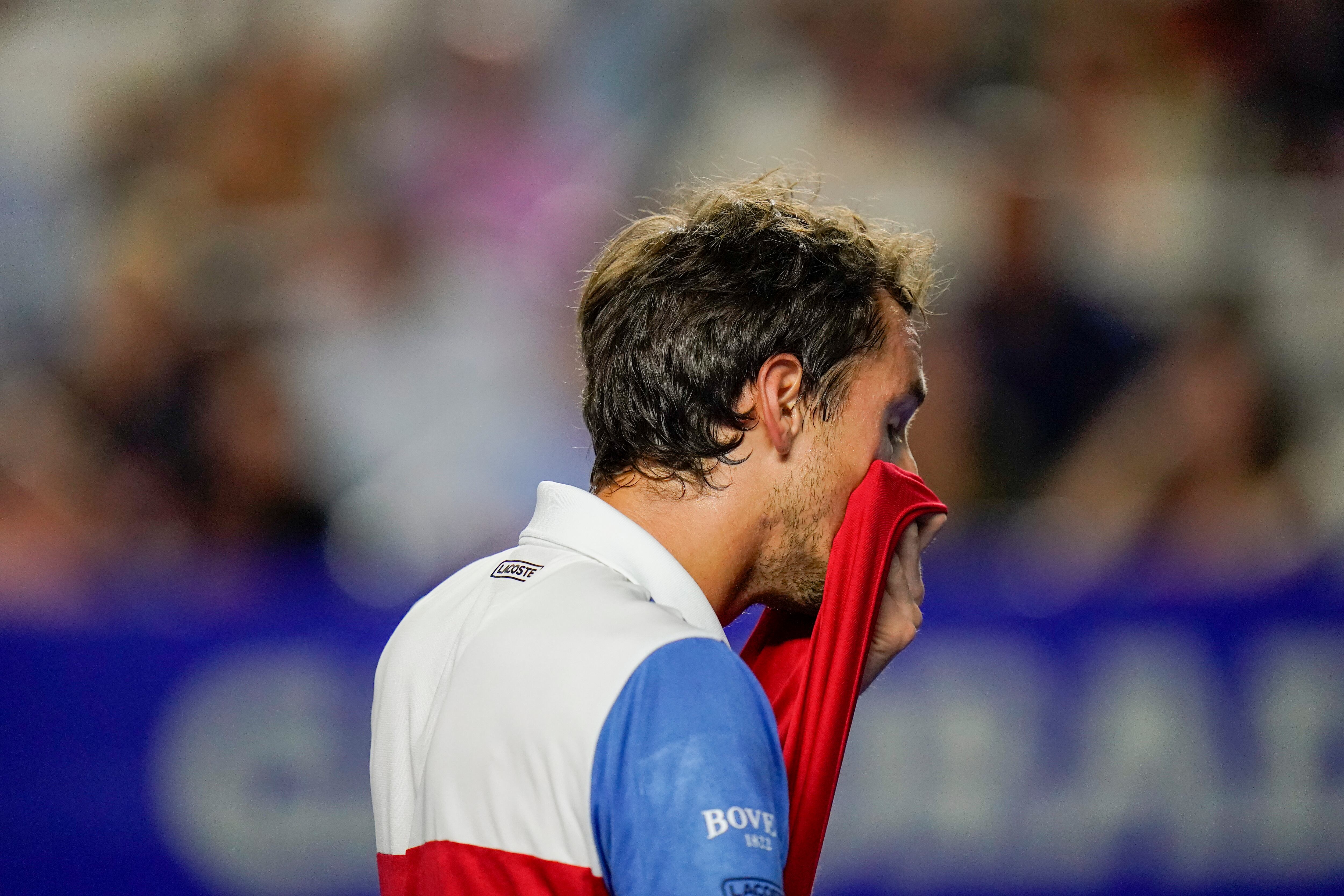 Russia's Daniil Medvedev wipes off sweat as he plays against Spain's Rafael Nadal in a semifinal match at the Mexican Open tennis tournament in Acapulco, Mexico, Friday, Feb. 25, 2022. (AP Photo/Eduardo Verdugo)