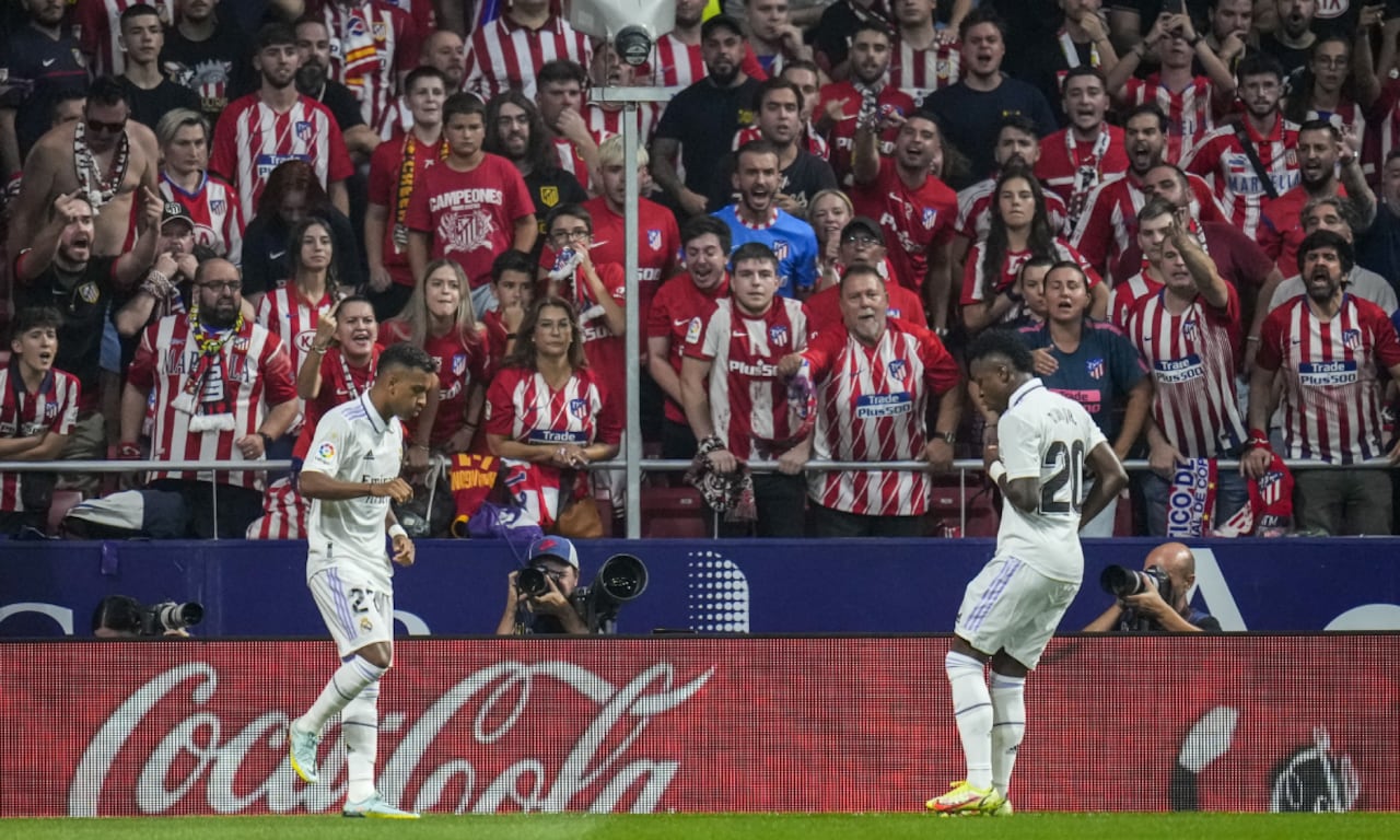 FILE - Real Madrid's Rodrygo, left, celebrates after scoring with his teammate Real Madrid's Vinicius Junior the opening goal during the Spanish La Liga soccer match between Atletico Madrid and Real Madrid at the Wanda Metropolitano stadium in Madrid, Spain, Sept. 18, 2022. With a goal and a dance, Real Madrid's young Brazilian forwards made a strong statement against racism in soccer this weekend. With their samba-like moves after a goal in the derby against Atletico on Sunday, Rodrygo and Vinícius Junior made it clear they are not backing down. (AP/Manu Fernandez)