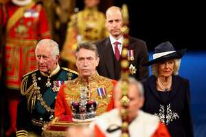 Britain's Prince Charles, Camilla, Duchess of Cornwall, and Britain's Prince William proceed behind the Imperial State Crown through the Royal Gallery for the State Opening of Parliament at the Palace of Westminster in London, Tuesday, May 10, 2022. Britain’s Parliament opens a new year-long session on Tuesday with a mix of royal pomp and raw politics, as Prime Minister Boris Johnson tries to re-energize his scandal-tarnished administration and revive the economy amid a worsening cost-of-living crisis. (Hannah McKay/Pool via AP)
