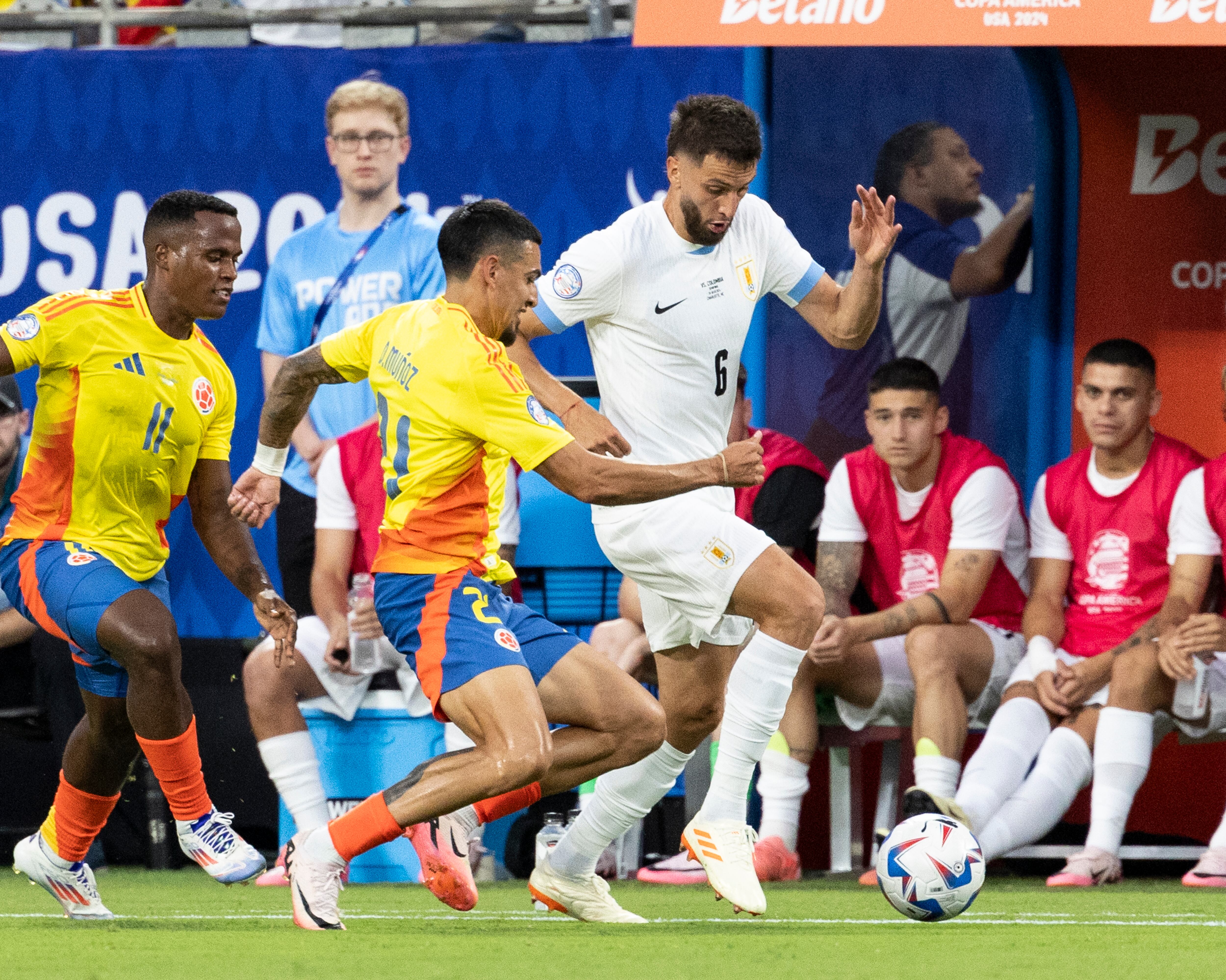 CHARLOTTE, NC - JULY 10: Rodrigo Bentancur #6 of Uruguay tries to avoid a challenge by Daniel Muñoz #21 of Colombia during a game between Uruguay and Colombia at Bank of America Stadium on July 10, 2024 in Charlotte, North Carolina. (Photo by Steve Limentani/ISI Photos/Getty Images)