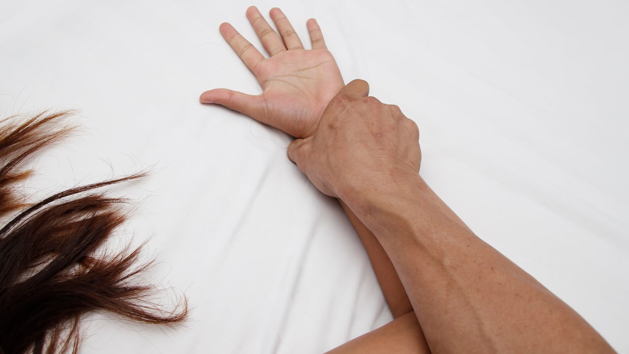 A hairy man's hand holding a woman hand for rape and sexual abuse concept