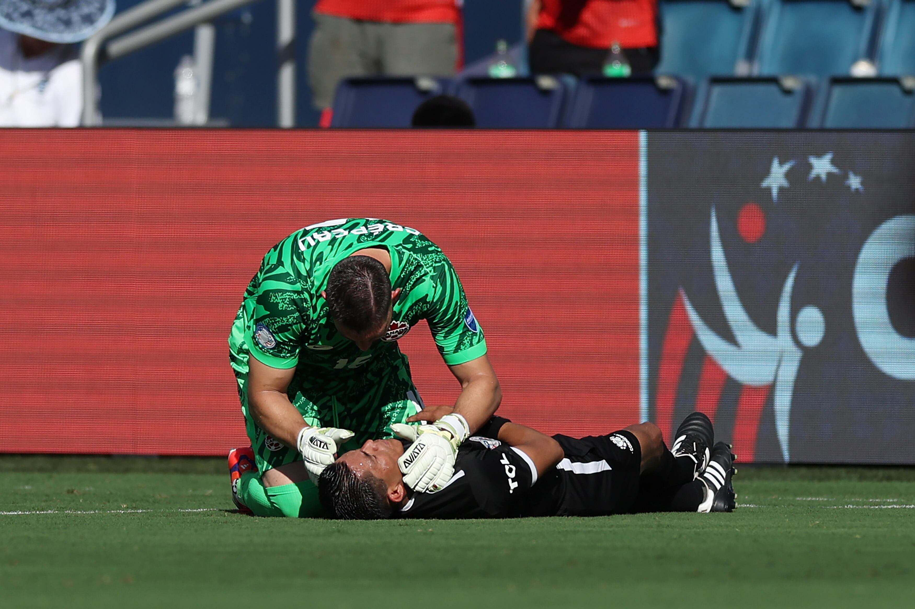 KANSAS CITY, KANSAS - JUNE 25: Maxime Crepeau of Canada aids assistant referee Humberto Panjoj during the CONMEBOL Copa America 2024 between Peru and Canada at Children's Mercy Park on June 25, 2024 in Kansas City, Kansas. (Photo by Jamie Squire/Getty Images)