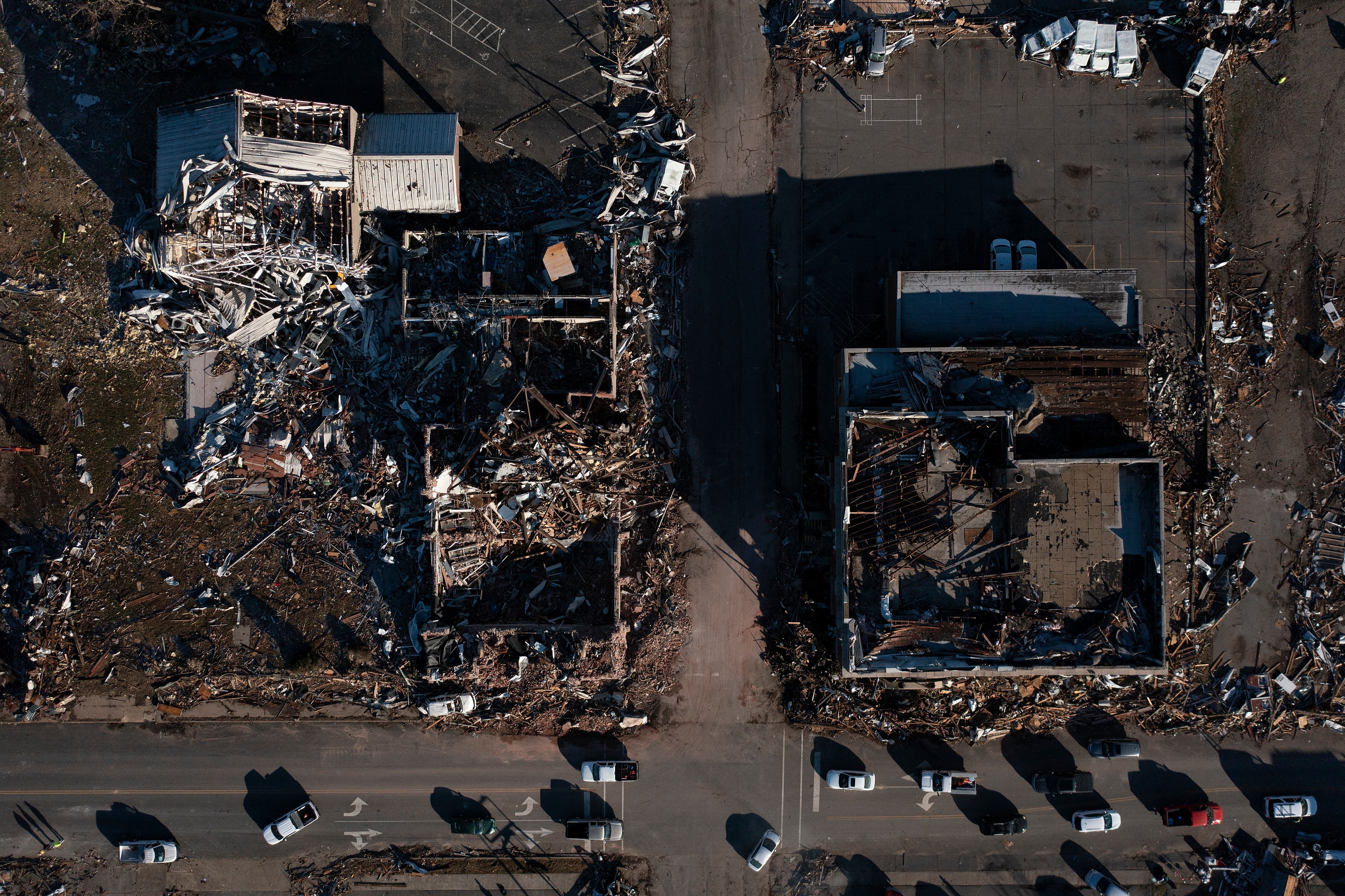 This aerial image shows tornado damage after extreme weather hit the region on December 12, 2021, in Mayfield, Kentucky. - Dozens of devastating tornadoes roared through five US states overnight, leaving more than 80 people dead on December 11, 2021 in what President Joe Biden said was "one of the largest" storm outbreaks in history. (Photo by Brendan Smialowski / AFP)