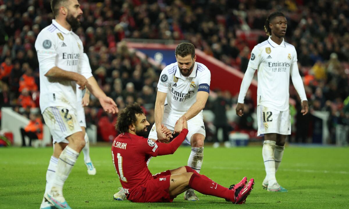 Soccer Football - Champions League - Round of 16 First Leg - Liverpool v Real Madrid - Anfield, Liverpool, Britain - February 21, 2023 Liverpool's Mohamed Salah and Real Madrid's Nacho REUTERS/Phil Noble