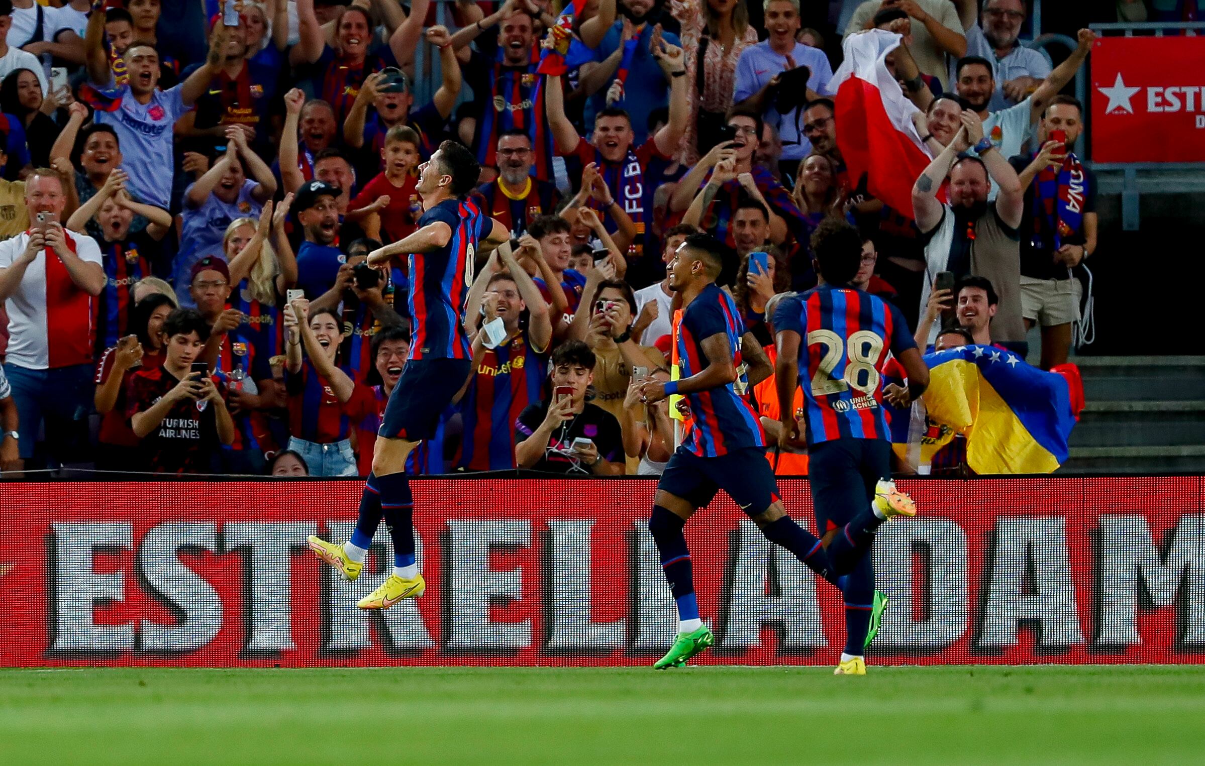 Barcelona's Robert Lewandowski, left, celebrates after scoring a goal during the Joan Gamper trophy soccer match between FC Barcelona and Pumas Unam at the Camp Nou Stadium in Barcelona, Spain, Sunday, Aug. 7, 2022. c (AP Photo/Joan Monfort)