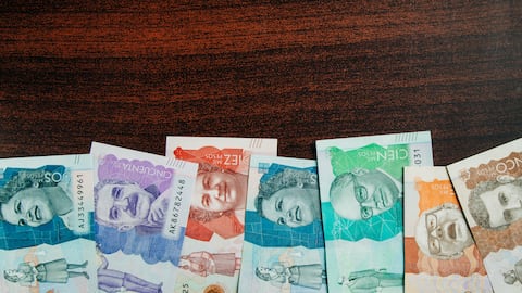 colombian money of different denominations in a wooden background