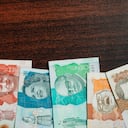 colombian money of different denominations in a wooden background