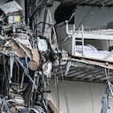 Rubble hangs from a partially collapsed building in Surfside north of Miami Beach, on June 24, 2021. - The multi-story apartment block in Florida partially collapsed early June 24, sparking a major emergency response. Surfside Mayor Charles Burkett told NBC�s Today show: �My police chief has told me that we transported two people to the hospital this morning at least and one has died. We treated ten people on the site.� (Photo by CHANDAN KHANNA / AFP)