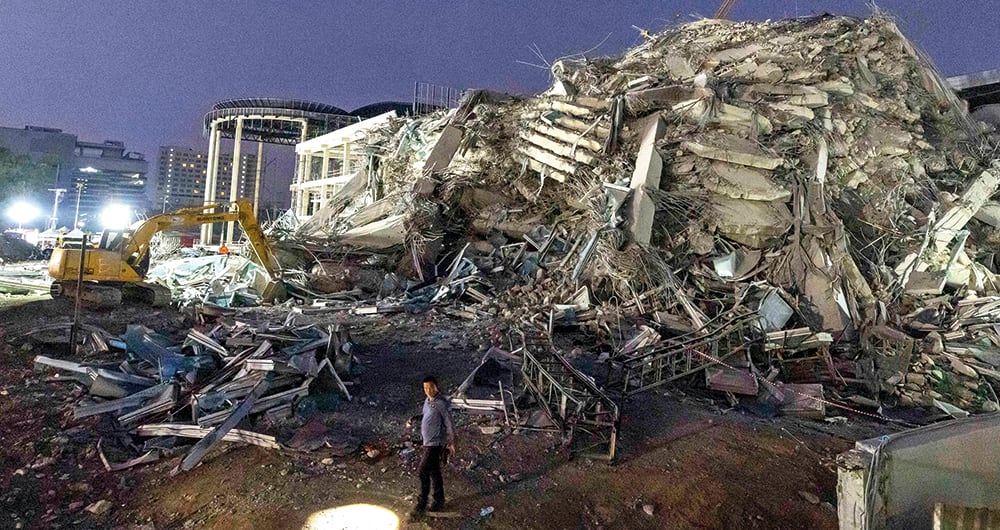 Rescuers search for victims at the site of a high-rise building under construction that collapsed after a strong earthquake in Bangkok, Thailand, early Saturday, March 29, 2025. (AP Photo/Wason Wanichakorn)