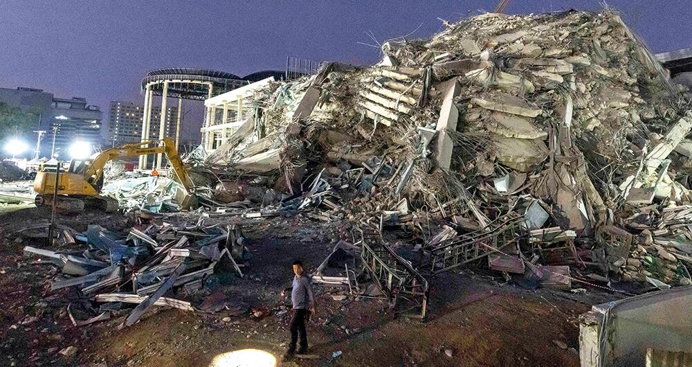 Rescuers search for victims at the site of a high-rise building under construction that collapsed after a strong earthquake in Bangkok, Thailand, early Saturday, March 29, 2025. (AP Photo/Wason Wanichakorn)