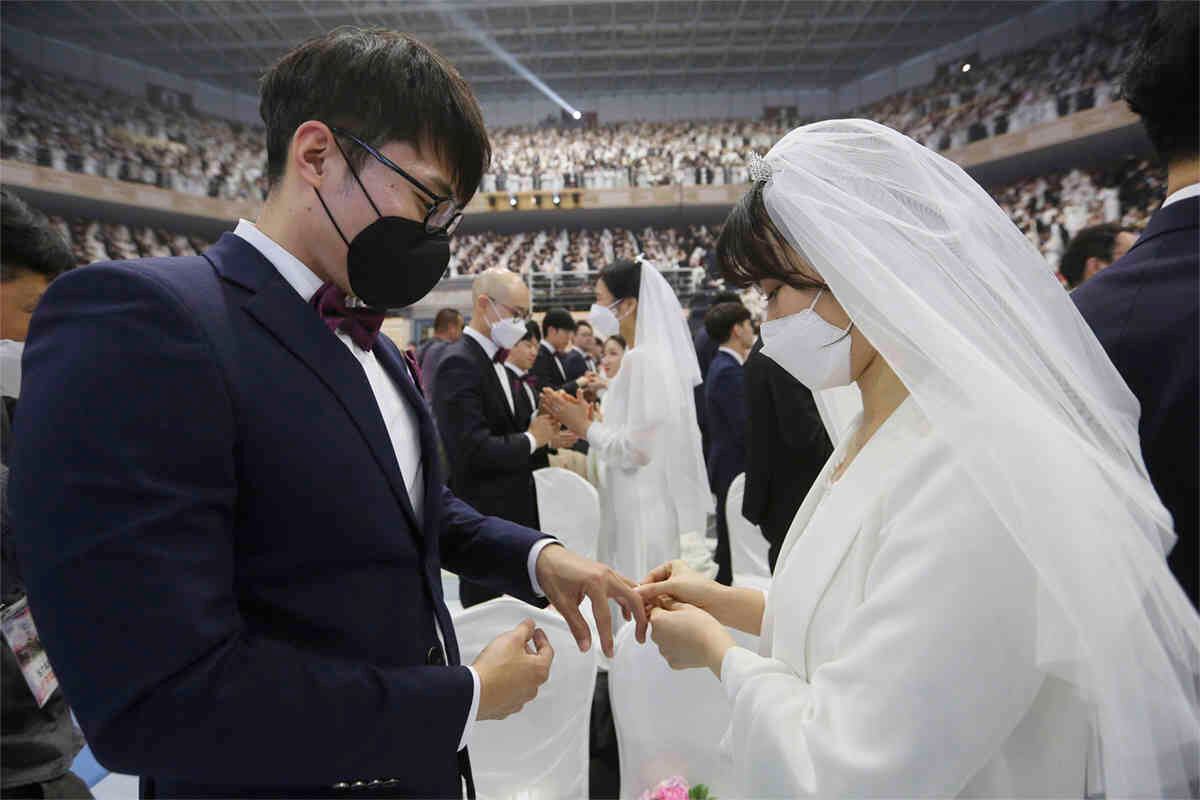 Una pareja, usando máscaras, intercambia sus anillos en una ceremonia de boda masiva en el Cheong Shim Peace World Center, en Corea del Sur, el 7 de febrero de 2020. Foto: Ahn Young-joon/ AP. 