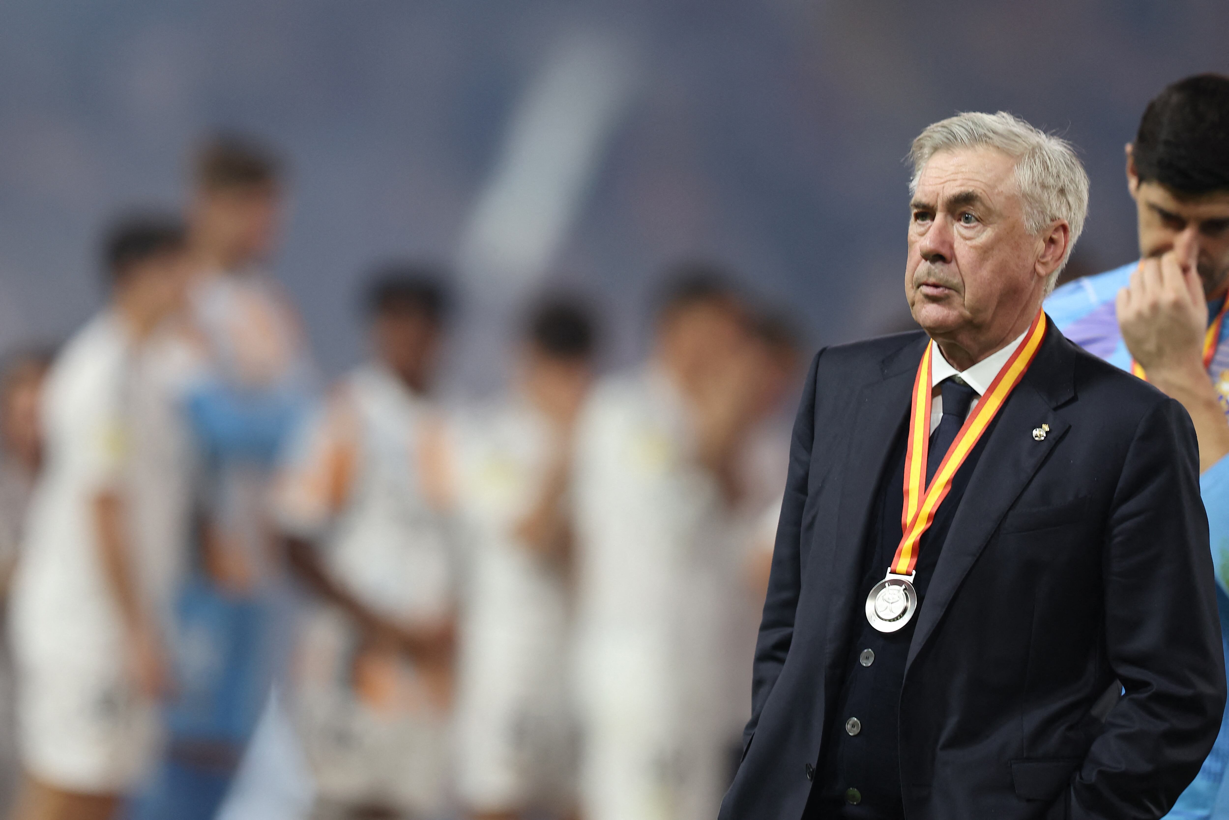Real Madrid's Italian coach Carlo Ancelotti walks after receiving his medal at the end of the Spanish Super Cup final football match between Real Madrid and Barcelona at the King Abdullah Sport City in Jeddah on January 12, 2025. (Photo by Haitham AL-SHUKAIRI / AFP)