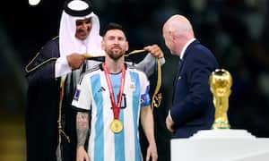 Soccer Football - FIFA World Cup Qatar 2022 - Final - Argentina v France - Lusail Stadium, Lusail, Qatar - December 18, 2022 Argentina's Lionel Messi, Emir of Qatar Sheikh Tamim bin Hamad Al Thani and FIFA president Gianni Infantino during the trophy ceremony REUTERS/Hannah Mckay