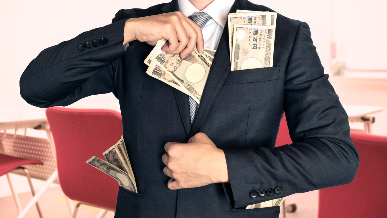 Businessman holding money at the seminar.