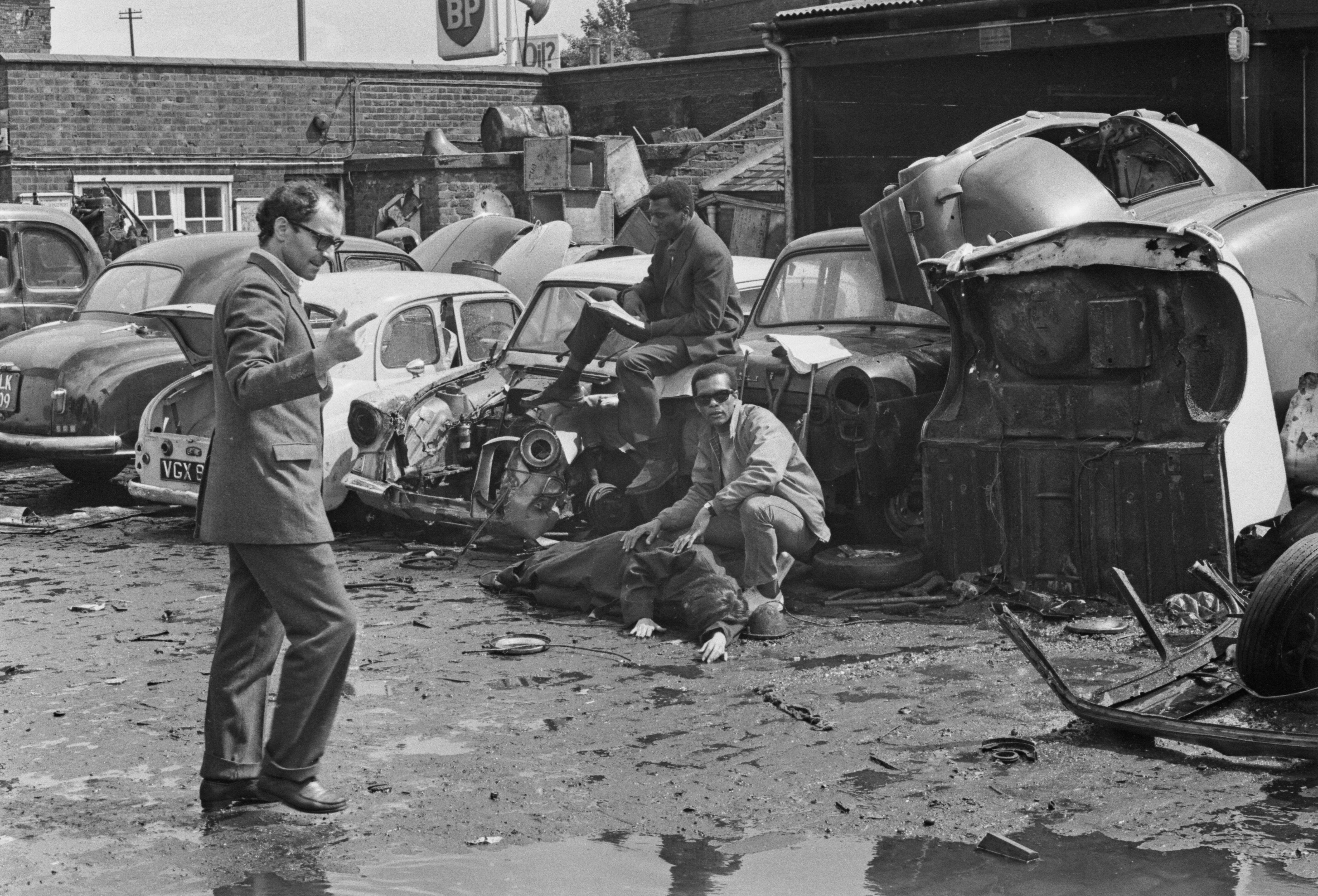French-Swiss film director, screenwriter, and film critic Jean-Luc Godard directing a scene with actors on the set of film 'One Plus One' (aka 'Sympathy For The Devil'), his first film in the English language, at Lombard Wharf, Port of London, UK, 24th July 1968. (Photo by Ian Tyas/Keystone Features/Hulton Archive/Getty Images)