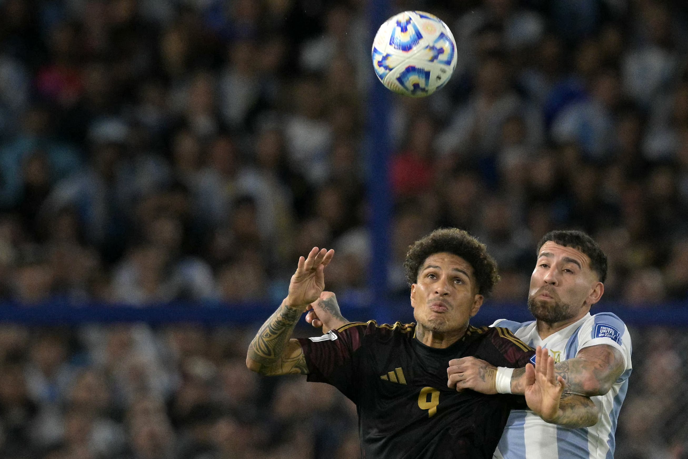 Peru's forward #09 Paolo Guerrero and Argentina's defender #19 Nicolas Otamendi jump for a header during the 2026 FIFA World Cup South American qualifiers football match between Argentina and Peru at the La Bombonera stadium in Buenos Aires on November 19, 2024. (Photo by JUAN MABROMATA / AFP)