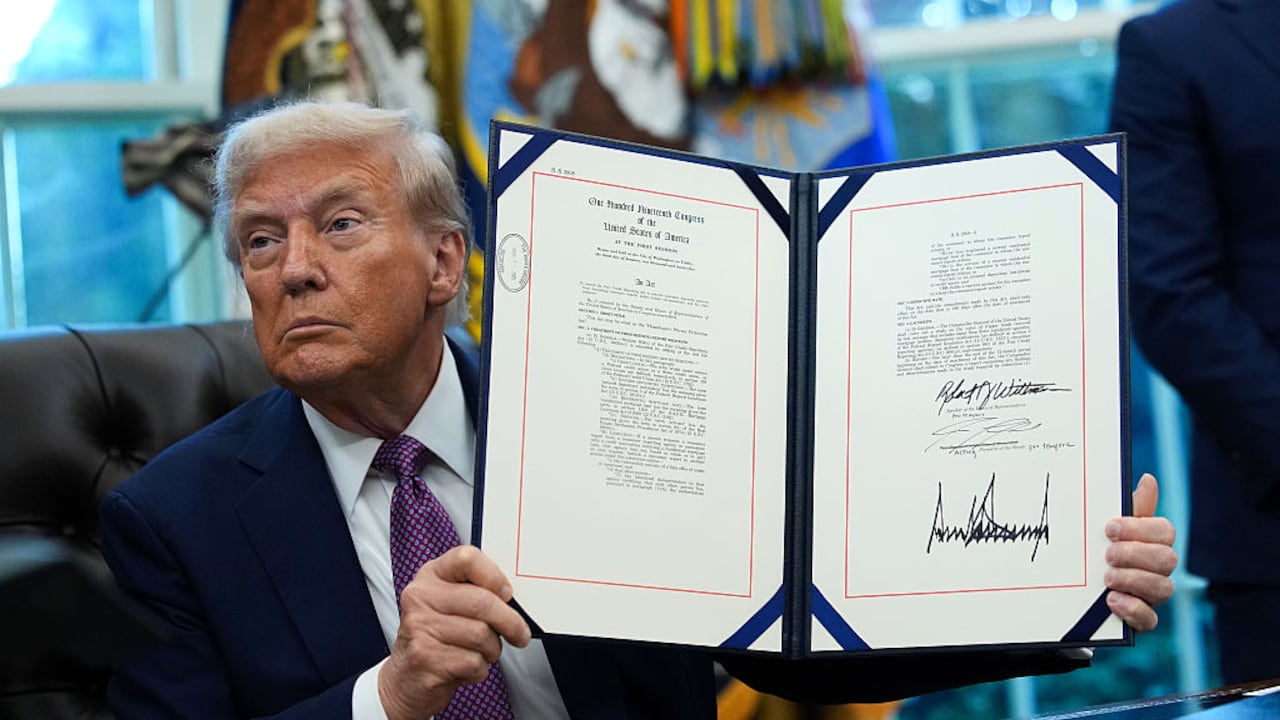 WASHINGTON, DC - SEPTEMBER 05: U.S. President Donald Trump displays a signed executive order amending the Fair Credit Reporting Act during a press availability in the Oval Office of the White House on September 05, 2025 in Washington, DC. President Trump signed executive orders which included the renaming of the Department of Defense to the Department of War. (Photo by Kevin Dietsch/Getty Images)