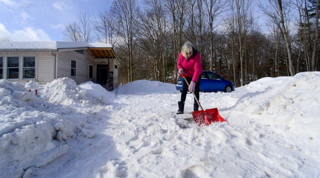 Janis Broom quita la nieve de su camino de entrada el lunes 17 de febrero de 2025, Brattleboro, Vermont, después de una tormenta invernal el domingo.