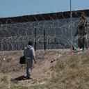 A migrant talks with a US member of the armed forces at the US-Mexico border in Ciudad Juárez, Mexico, Sunday, April 30, 2023. (AP Photo/Christian Chávez)