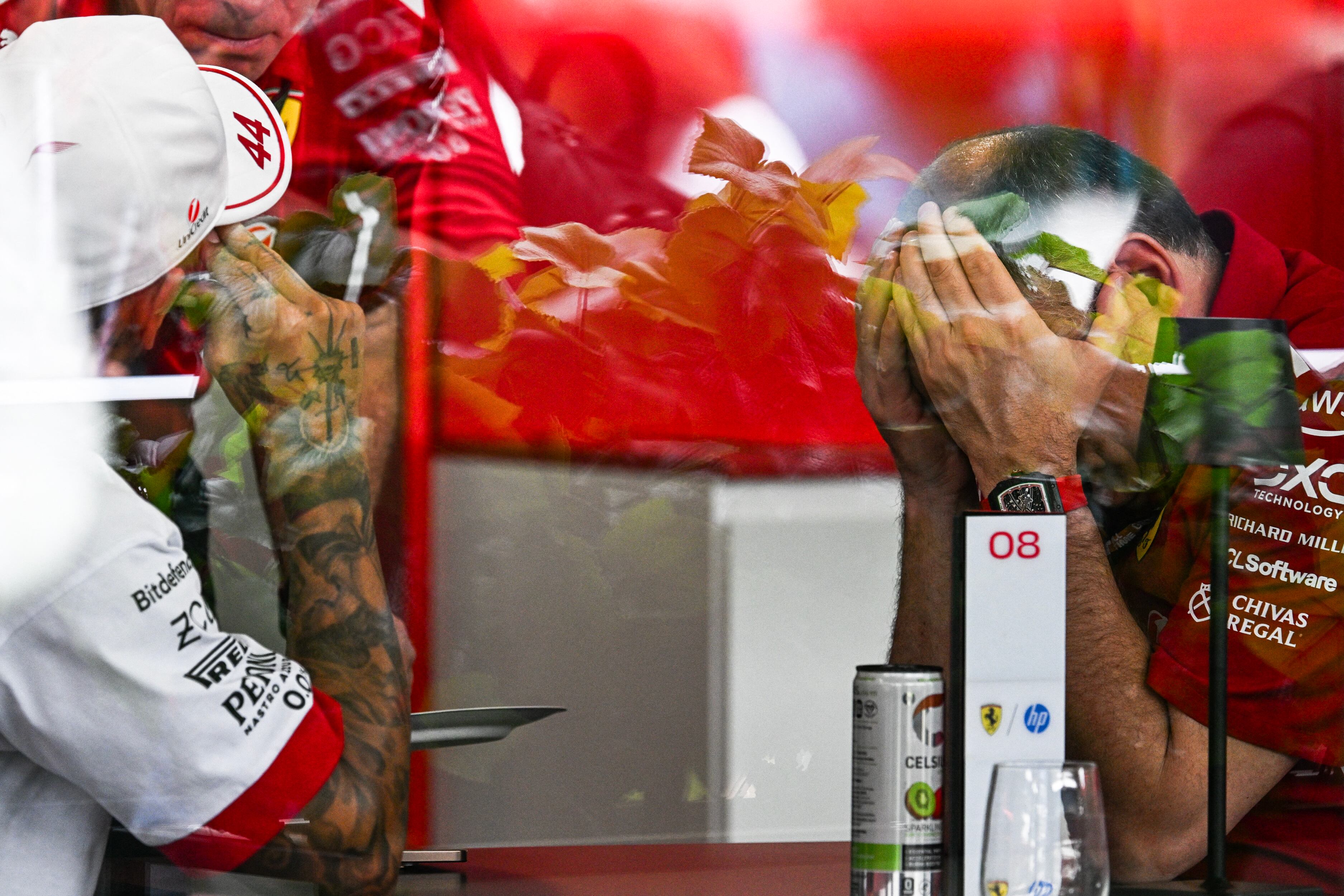 (L-R) Ferrari's British driver Lewis Hamilton Ferrari's and French team principal Frederic Vasseur speak with each other before the start of the 2025 Miami Formula One Grand Prix at Miami International Autodrome in Miami Gardens, Florida, on May 4, 2025. (Photo by CHANDAN KHANNA / AFP)