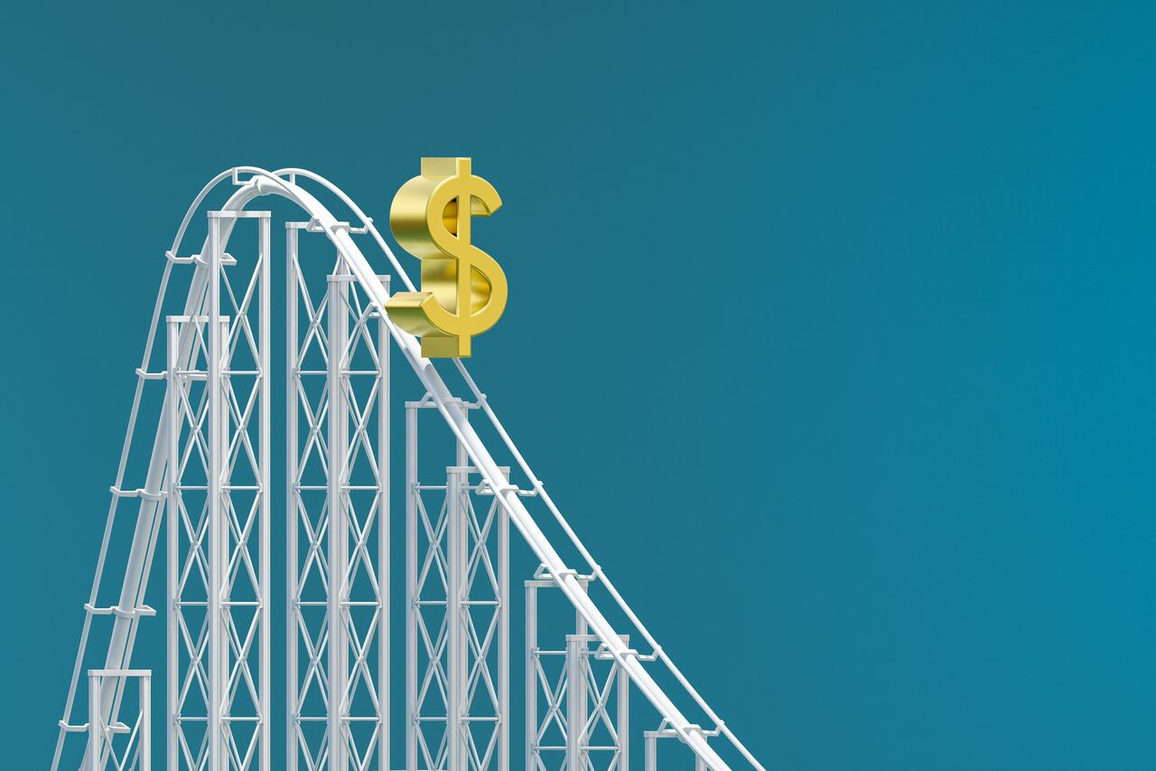 computer generated image of a dollar sign on a rollercoaster track on a blue background. Dollar value decreasing concept illustration.