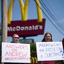 ELIZABETH CITY, NC - APRIL 23: Robin Woodard, left, and Brian Murrey, center, block an intersection in front of a McDonalds during a protest march April 23, 2021 in Elizabeth City, North Carolina. Protestors gathered before elected officials discussed the possible release of police body camera footage from the shooting death of Andrew Brown Jr. on April 21. Sean Rayford/Getty Images/AFP (Photo by Sean Rayford / GETTY IMAGES NORTH AMERICA / Getty Images via AFP)