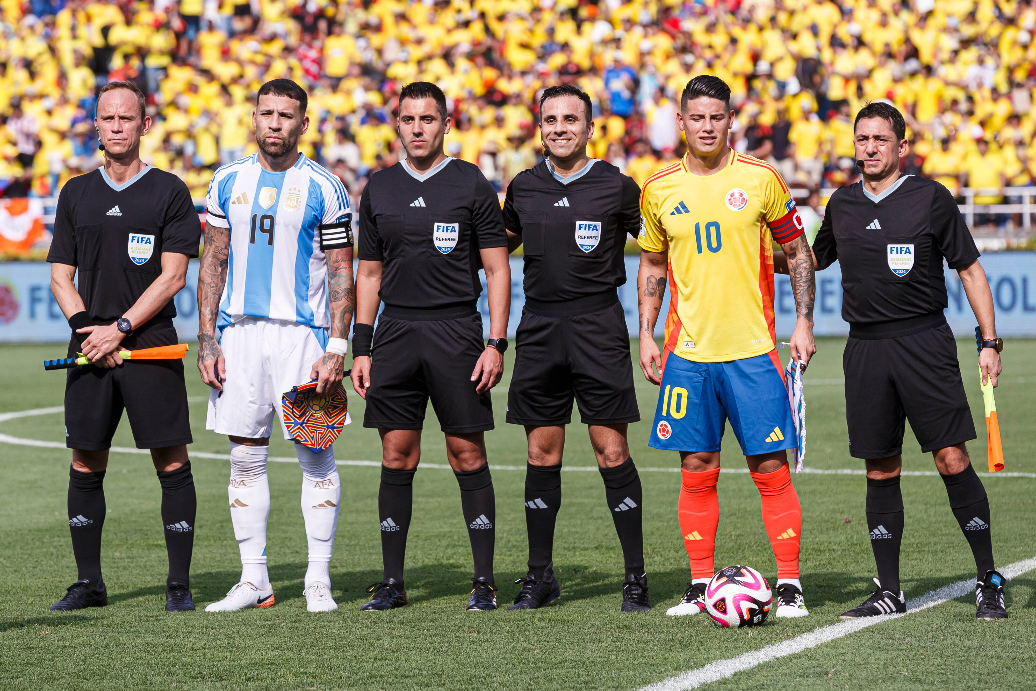 BARRANQUILLA, COLOMBIA - SEPTEMBER 10: Nicolas Otamendi of Argentina (L) and James Rodriguez of Colombia (R) poses for official photo with referees during the FIFA World Cup 2026 Qualifier match between Colombia and Argentina at Roberto Melendez Metropolitan Stadium on September 10, 2024 in Barranquilla, Colombia. (Photo by Martín Fonseca/Eurasia Sport Images/Getty Images)