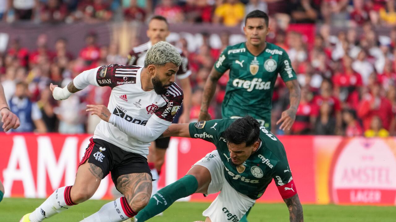 Gabi of Brazil's Flamengo, left, and Gustavo Gomez of Brazil's Palmeiras battle for the ball during the Copa Libertadores final soccer match in Montevideo, Uruguay, Saturday, Nov. 27, 2021. (AP Photo/Matilde Campodonico)