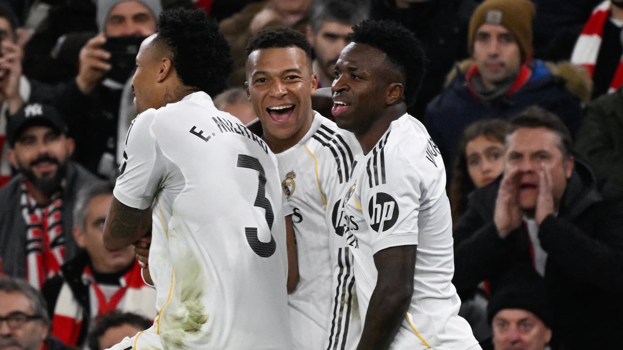 El delantero del Real Madrid, Kylian Mbappé, festeja su anotación ante la compañía de Vinicius Junior y Eder Militao, en el juego ante el Athletic de Bilbao, en LaLiga española. (Foto ANDER GILLENEA / AFP)