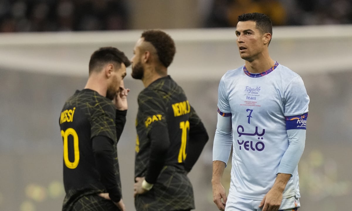 Cristiano Ronaldo playing for a combined XI of Saudi Arabian teams Al Nassr and Al Hilal is flanked by PSG's Lionel Messi and his teammate Neymar during a friendly soccer match, at the King Saud University Stadium, in Riyadh, Saudi Arabia, Thursday, Jan. 19, 2023. (AP/Hussein Malla)