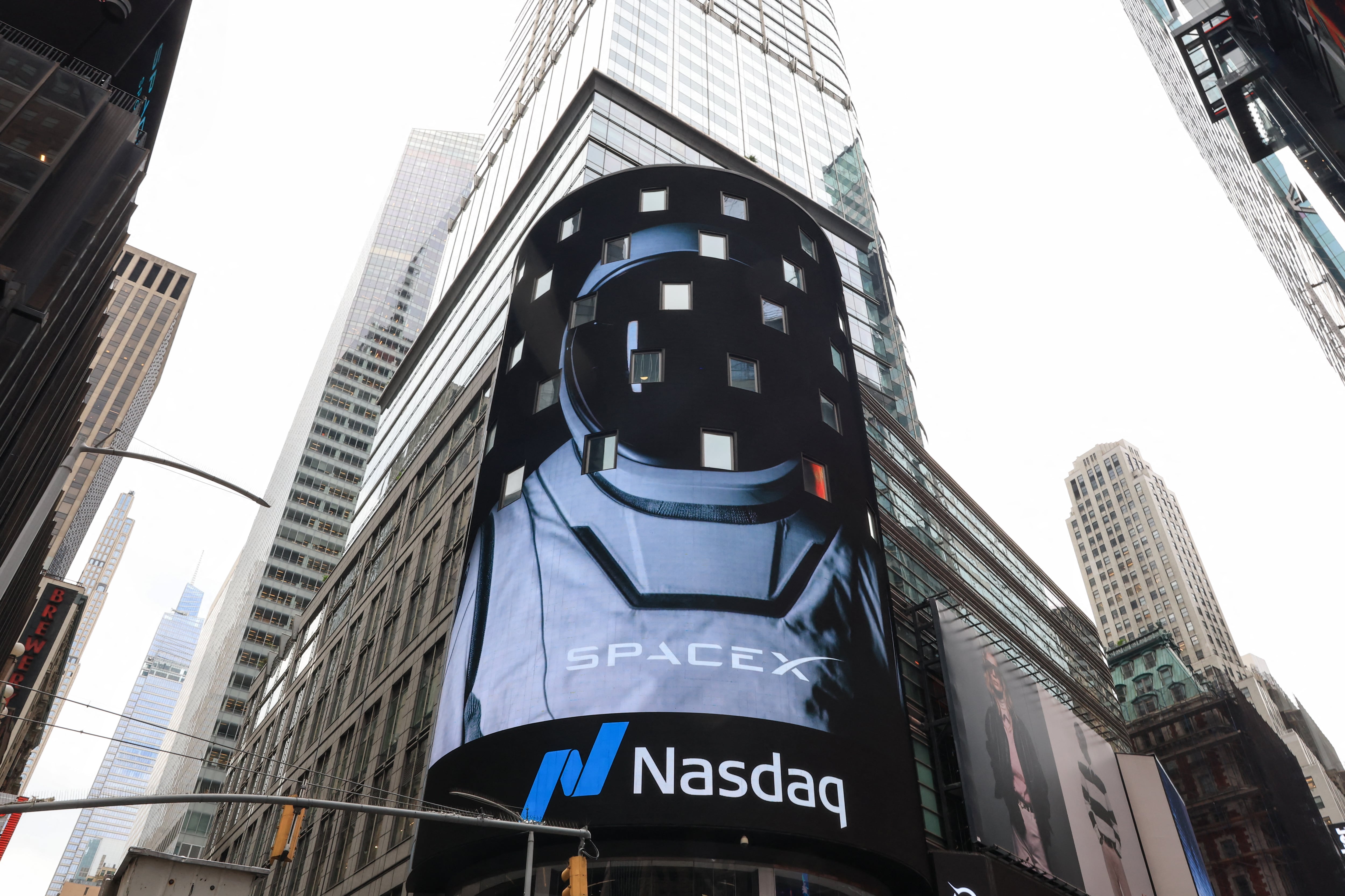 A view of the Nasdaq MarketSite after SpaceX company executives rang the opening bell to celebrate the launch of SpaceX�s initial public offering (IPO) in New York on June 12, 2026. Elon Musk's SpaceX begins trading on the Nasdaq exchange on Friday with the biggest initial public offering in history expected to make the polarizing entrepreneur the world's first trillionaire. The company priced more than 555 million shares at $135 each in a filing with the US markets regulator on Thursday, placing SpaceX in the top 10 of Wall Street's biggest companies with a valuation of just under $1.8 trillion -- ahead of Tesla, Facebook-owner Meta and Walmart. (Photo by TIMOTHY A. CLARY / AFP)
