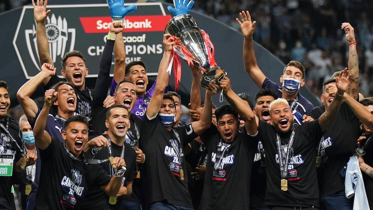 Players of Mexico's Monterrey celebrate with the trophy on the podium after defeating 1-0 Mexico's America during the CONCACAF Champions League final soccer match in Monterrey, Mexico, Thursday, Oct. 28, 2021. (AP Photo/Fernando Llano)
