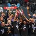 Players of Mexico's Monterrey celebrate with the trophy on the podium after defeating 1-0 Mexico's America during the CONCACAF Champions League final soccer match in Monterrey, Mexico, Thursday, Oct. 28, 2021. (AP Photo/Fernando Llano)