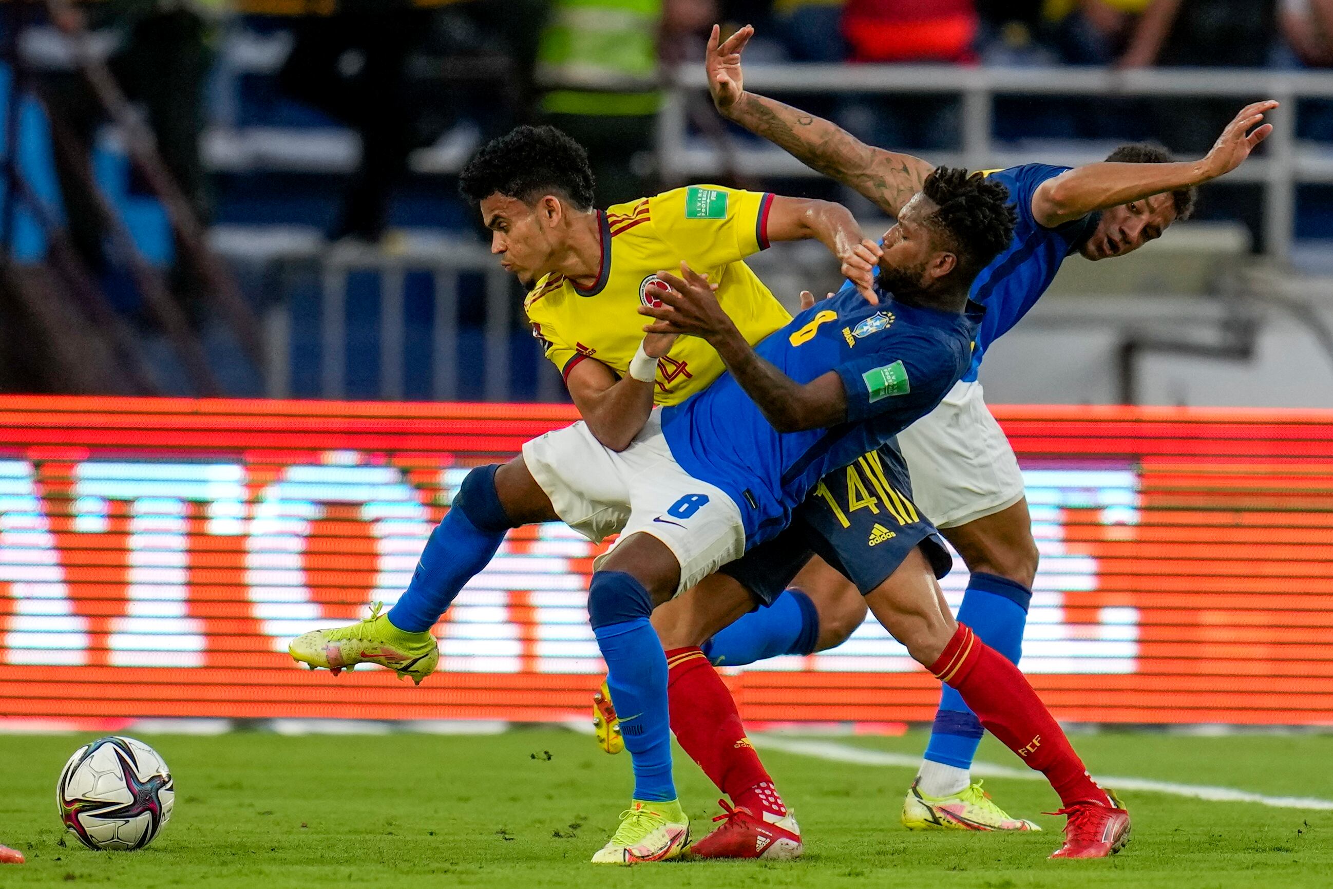 Colombia's Luis Diaz (14) and Brazil's Fred battle for the ball during a qualifying soccer match for the FIFA World Cup Qatar 2022 in Barranquilla, Colombia, Sunday, Oct. 10, 2021. (AP Photo/Fernando Vergara)