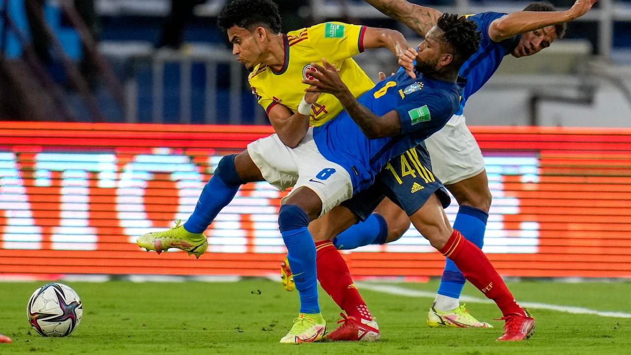 Colombia's Luis Diaz (14) and Brazil's Fred battle for the ball during a qualifying soccer match for the FIFA World Cup Qatar 2022 in Barranquilla, Colombia, Sunday, Oct. 10, 2021. (AP Photo/Fernando Vergara)