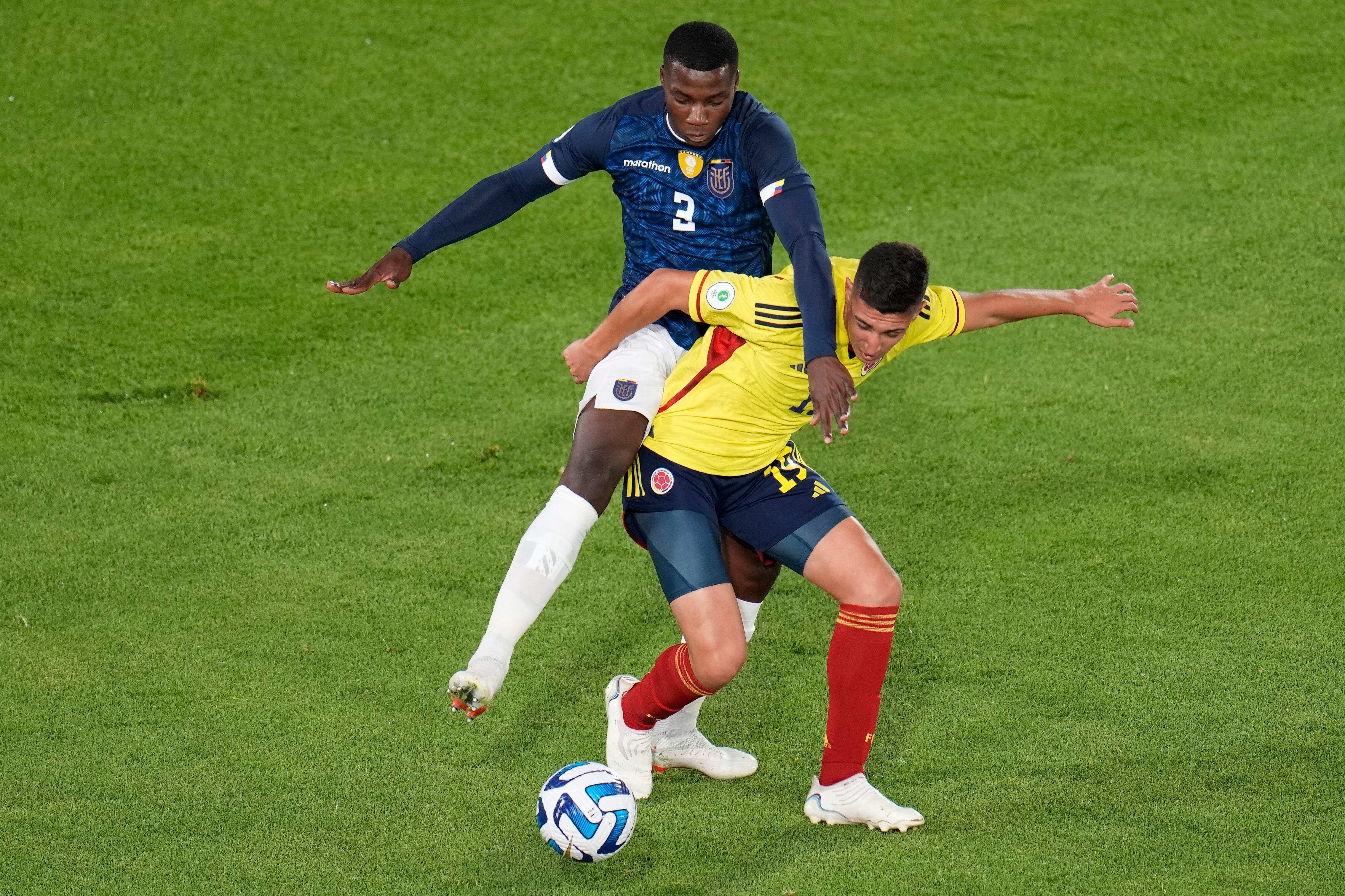 Ecuador's Luis Cordova, left, and Colombia's Miguel Monsalve battle for the ball during a South America U-20 Championship soccer match in Bogota, Colombia, Monday, Feb. 6, 2023. (AP Photo/Fernando Vergara)