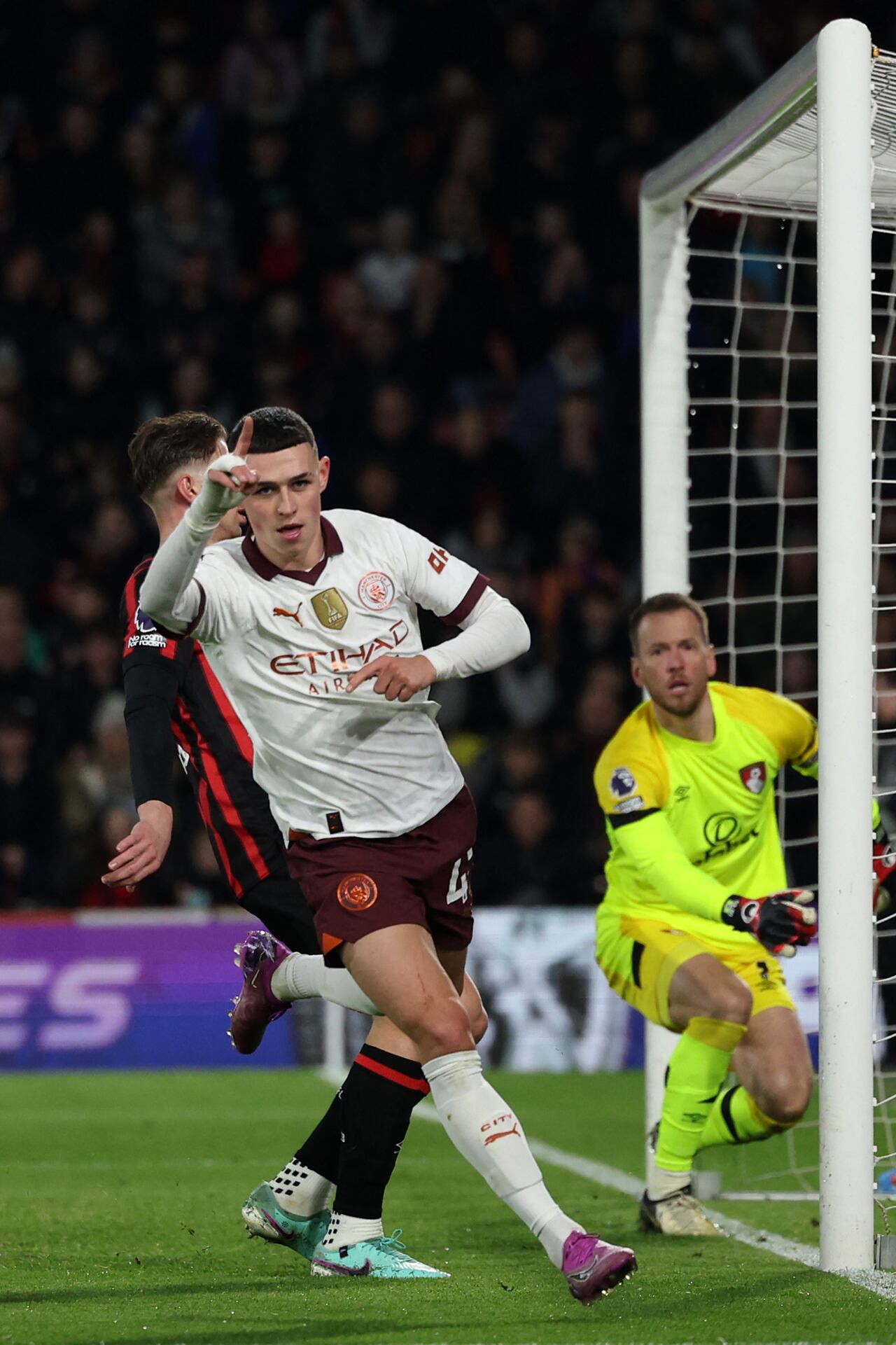 Manchester City's English midfielder #47 Phil Foden celebrates after scoring the opening goal of the English Premier League football match between Bournemouth and Manchester City at the Vitality Stadium in Bournemouth, southern England on February 24, 2024. (Photo by Adrian DENNIS / AFP) / RESTRICTED TO EDITORIAL USE. No use with unauthorized audio, video, data, fixture lists, club/league logos or 'live' services. Online in-match use limited to 120 images. An additional 40 images may be used in extra time. No video emulation. Social media in-match use limited to 120 images. An additional 40 images may be used in extra time. No use in betting publications, games or single club/league/player publications. /