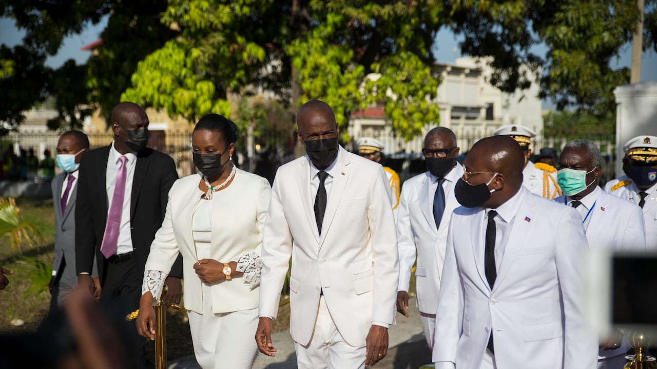 FILE - In this May 18, 2021 file photo, Haitian President Jovenel Moise, center, walks with First Lady Martine Moise, left, and interim Prime Minister Claude Joseph, right, during a ceremony marking the 218th anniversary of the creation of the Haitian flag in Port-au-Prince, Haiti. Moïse was assassinated in an attack on his private residence early Wednesday, and the first lady was shot in the overnight attack and hospitalized, according to a statement from Joseph. (AP Photo/Joseph Odelyn, File)