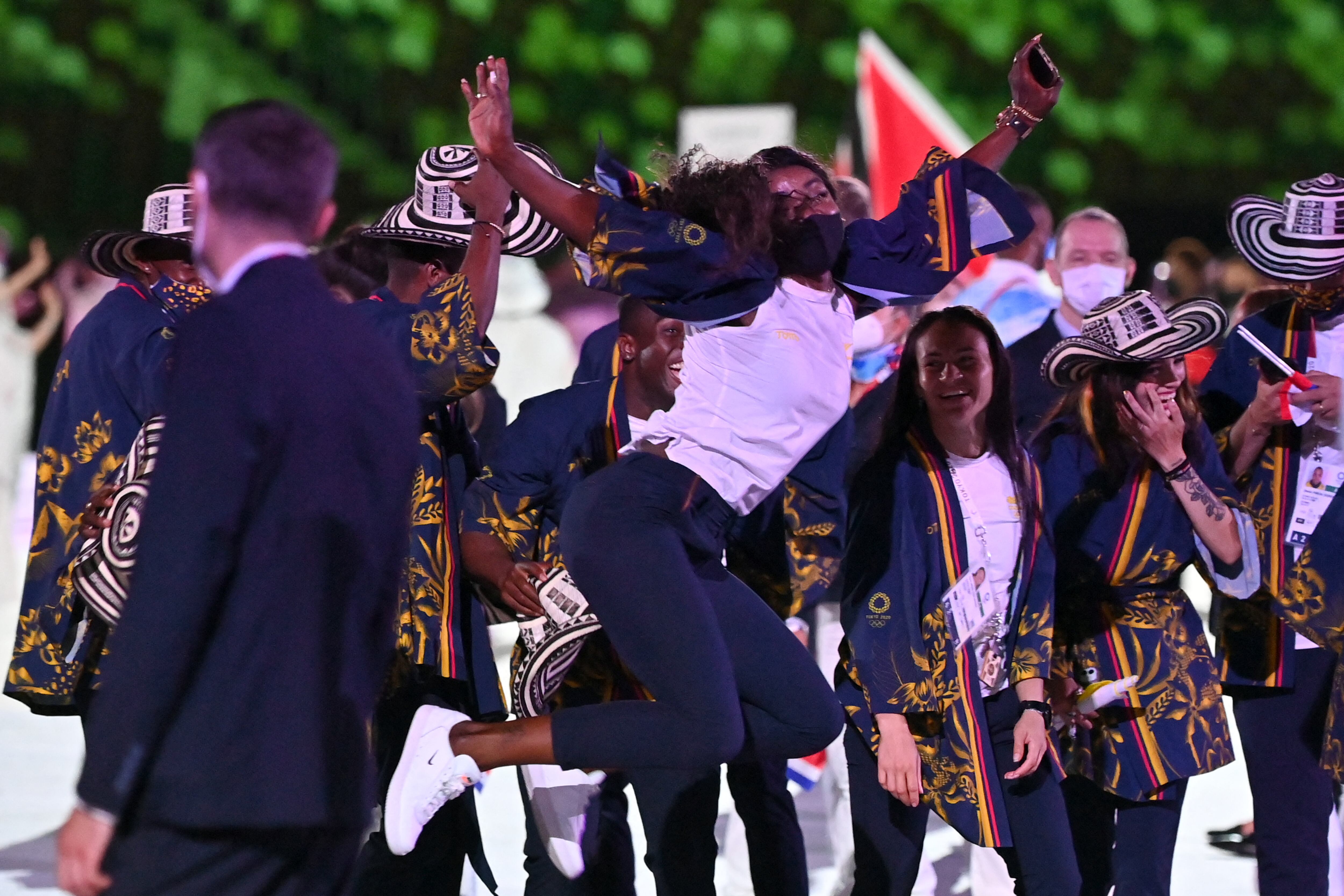Colombia's flag bearer Caterine 	Ibarguen jumps for a photo  during the opening ceremony of the Tokyo 2020 Olympic Games, at the Olympic Stadium, in Tokyo, on July 23, 2021. (Photo by Andrej ISAKOVIC / AFP)